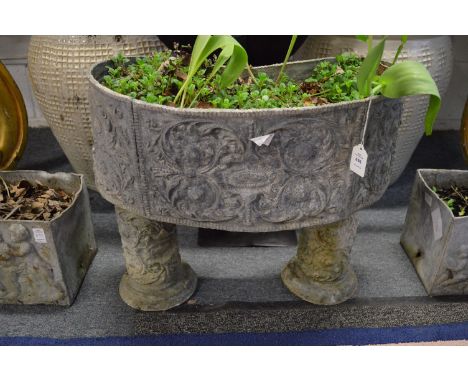 A good lead planter of curving form together with a pair matching stands.