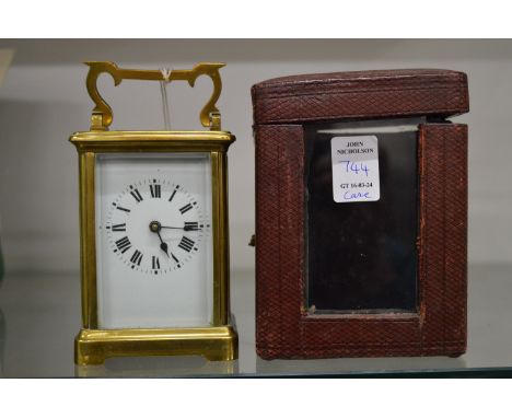 A French brass carriage clock with leather travelling case.