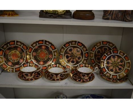 Two pairs of Royal Crown Derby Imari plates, three similar smaller plates and three cups and saucers.