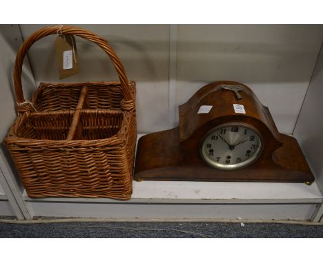 A walnut mantle clock and a wicker four bottle carrier.