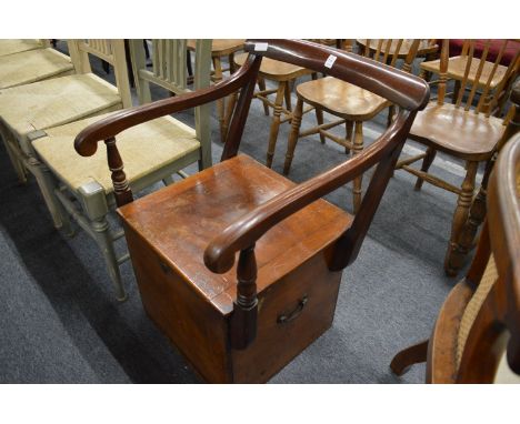 A mahogany commode chair.