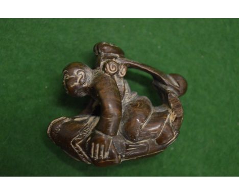 A carved wood netsuke.