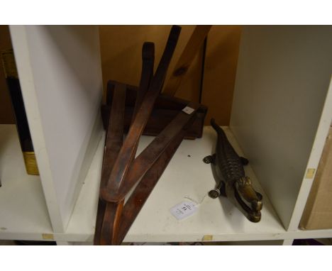 A cast metal crocodile nut cracker and a pair of wooden wall brackets.
