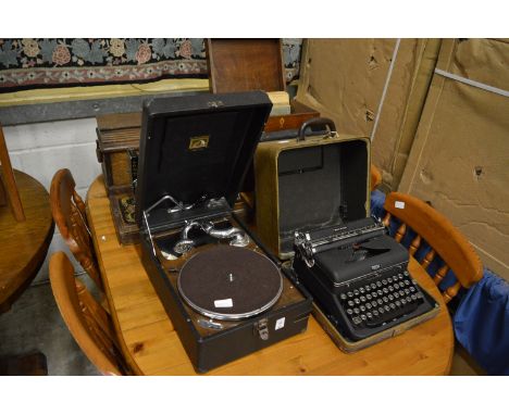 An HMV portable gramophone, gramophone records an old Royal typewriter and a Singer sewing machine.