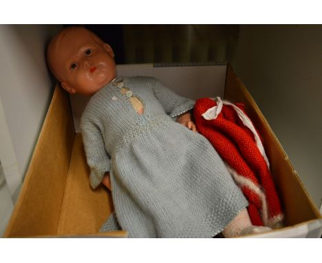 A doll and boxed model cars.