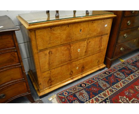 A 19th century Biedermeier satinwood three drawer commode.