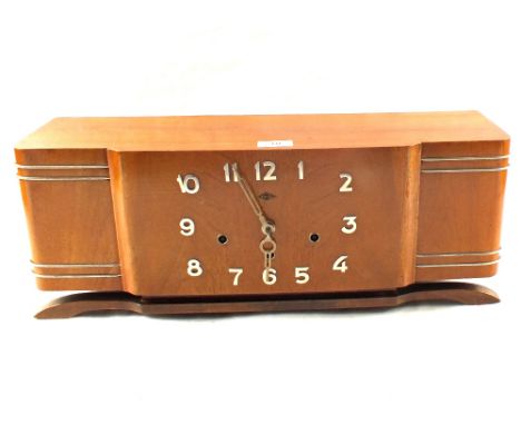 An Art Deco French mahogany striking mantel clock