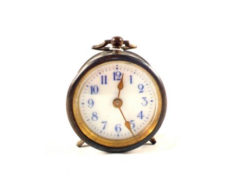 A small metal alarm clock