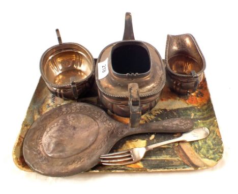 A silver three piece tea set (lid detached), a fork and a mirror frame