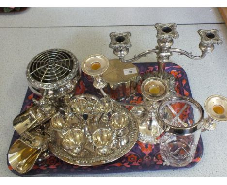 A silver plated tea caddy, candelabra, egg cruet plus other silver plate