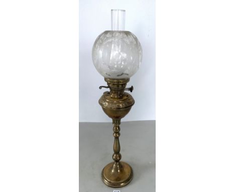 Antique brass oil lamp with etched clear glass shade and glass chimney. Total height 31". Scuffs on bottom rim of shade
