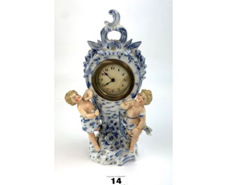 Continental china mantle clock with cherubs, crossed swords mark, 9.5" high