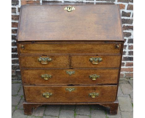 Georgian oak bureau with swan neck handles, bracket feet, reeded columns and compartmental interior with concealed drawer