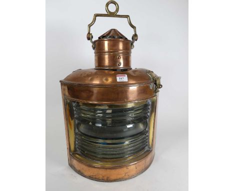 An antique brass and copper ship's light, height 48cmThe burner has been replaced with a lamp.The glass has several chips but