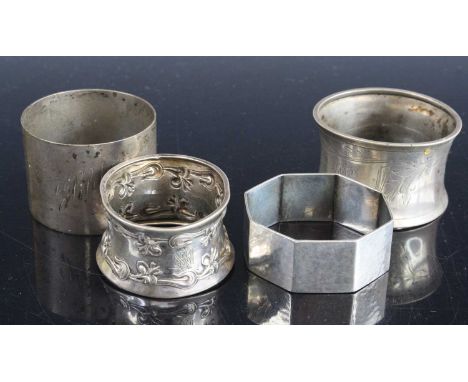 An early 20th century German silver napkin ring of hexagonal form with planished finish, stamped 800, together with three oth