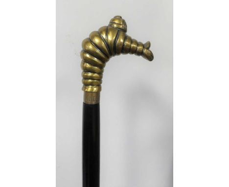 A walking stick, the brass handle in the form of the Michelin man, length 98cm 