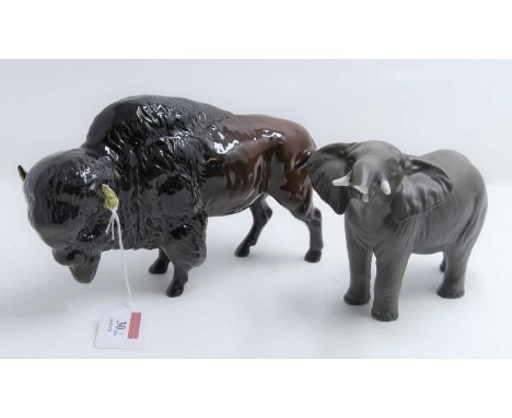 A Beswick matt glazed pottery figure of an elephant, modelled standing with trunk raised, height 12cm, together with a Beswic
