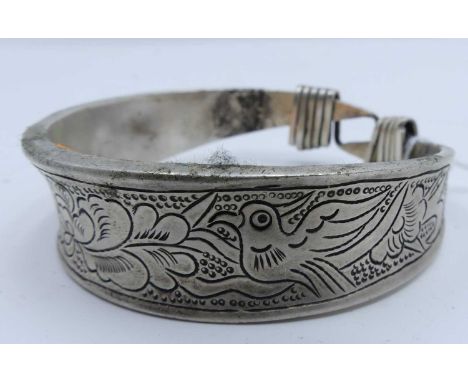 A Chinese white metal bangle engraved with birds and flowers
