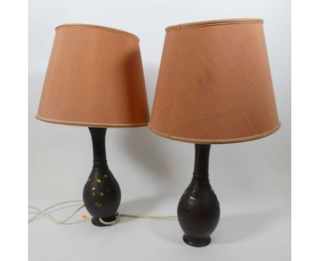 A pair of Japanese gilt decorated metal table lamps, each of baluster form, each relief decorated with birds amongst flowers,