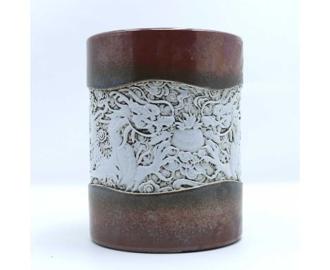 A Chinese pottery brush pot, relief decorated with dragons, impressed seal mark to the underside, height 14cmAppears in good 