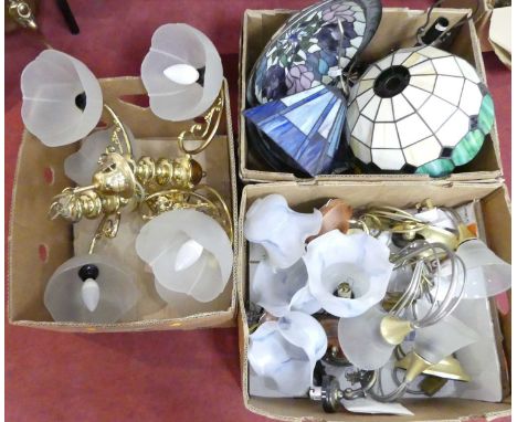 A collection of lighting and shades, to include Tiffany style coloured glass lampshades, polished brass three-branch chandeli