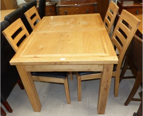 A modern light oak dining suite comprising extending table and 4 ladder back chairs