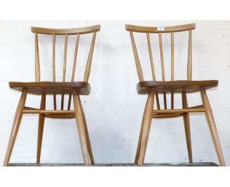 A pair of Ercol stick back dining chairs