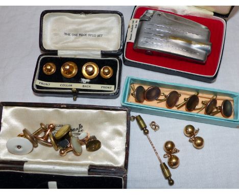 A pair of gold cufflinks; a selection of gilt metal buttons and studs; a cigarette lighter