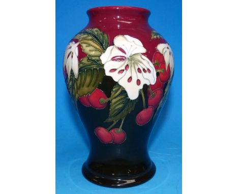 A modern Moorcroft inverted baluster vase decorated with white flowers and red berries, crimson and black ground, impressed, 