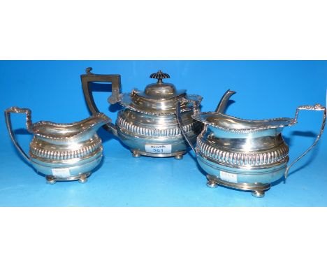 An early 20th century silver tea service of Georgian boat shaped design, maker GN RH., teapot date letter rubbed, cream and s