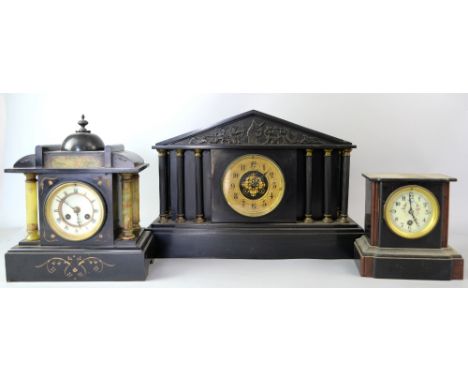 Three slate mantel clocks .     