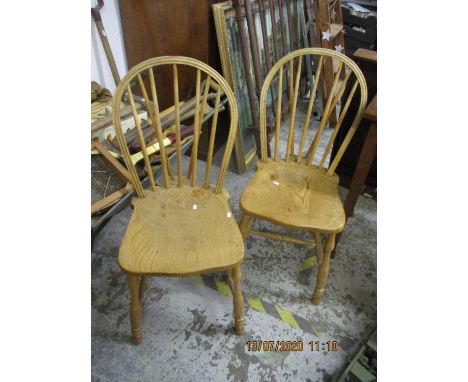 A pair of light elm seated Windsor stick back chairs 