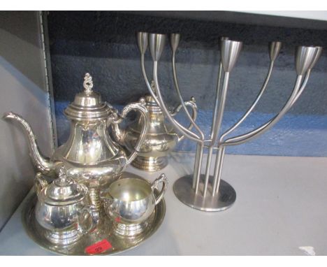 A silver plated teaset comprising four pieces together with a silver plated tray and a K Hogberg design candelabra 