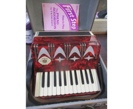 A cased Firotti accordion 