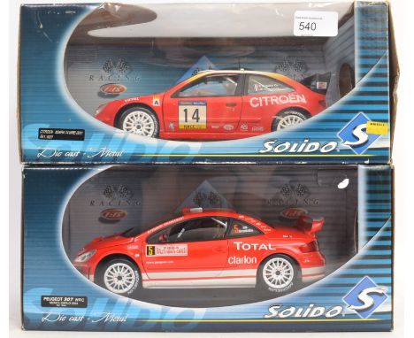 SOLIDO: Two Solido 1:18 scale diecast model cars, each within the original boxes; Peugeot 307 WRC and a Citroen Xsara WRC 200