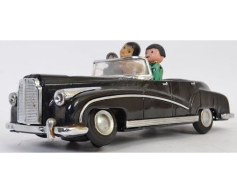 TINPLATE: A vintage Hong Kong tinplate ' Photographer In Car ' battery operated toy model car. 