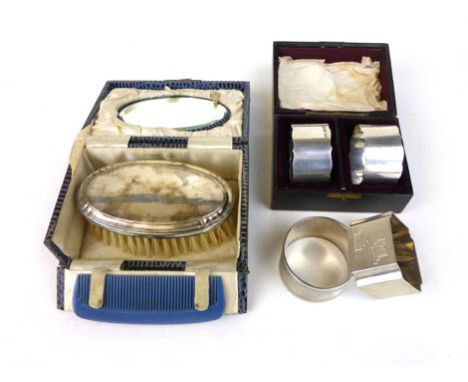 A pair of silver napkin rings, two further napkin rings and a cased brush mirror and comb set. (parcel)