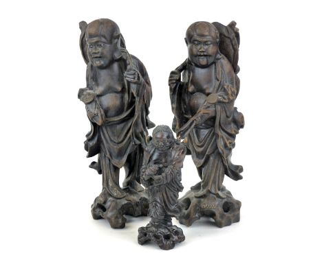 A pair of Chinese root carvings of immortals carrying scepters, h. 32 cm, together with another similar smaller (3) CONDITION