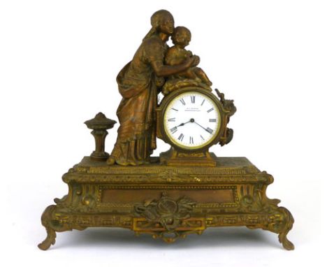 A bronzed spelter mantle clock, the enamelled dial inscribed 'R C Marsh, Birmingham and Paris', surmounted by a classical mot