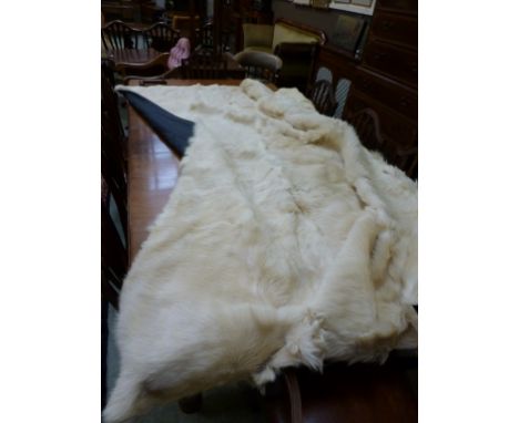 A large goat skin bed spread or blanket, black silk backing 230 cm x 210 cm approximately. CONDITION REPORT: Good