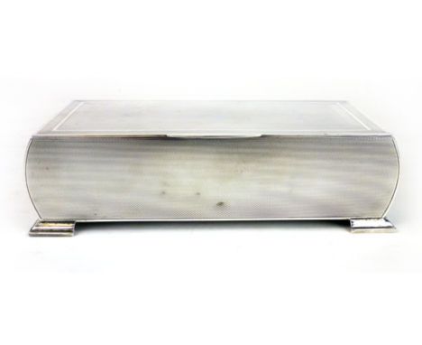 A silver table cigarette casket with engine turned decoration, makers mark JR Birmingham 1939.  l. 20 cm CONDITION REPORT: Go