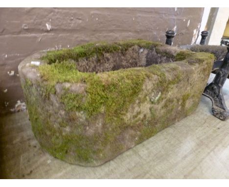 A stone trough with a bowed end. l. 65 cm.