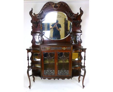 An Edwardian mahogany display cabinet, with Chippendale style chinoiserie fret work, above the shaped oval plate, on a base w