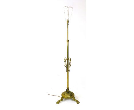 A brass telescopic lamp standard, early 20th century, with Art Nouveau style swirling decoration on a tripod base, maximum h.