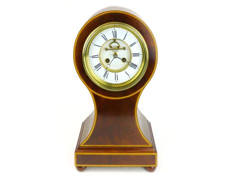 A mahogany and boxwood with inlaid balloon mantle clock, circa. 1900, the white enamelled 6 3/4" chapter ring enclosing a vis
