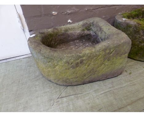 A stone horseshoe shaped trough with central plug hole. l. 50 cm