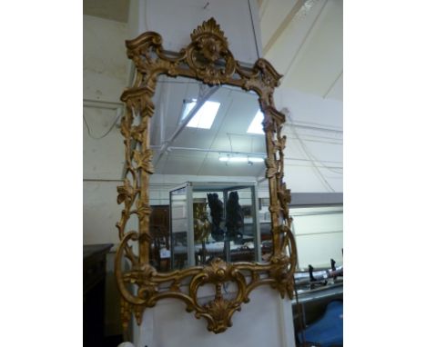 A Chippendale style wall mirror, probably early 20th century, with a Rococo scrolling foliate frame with gilded decoration. h