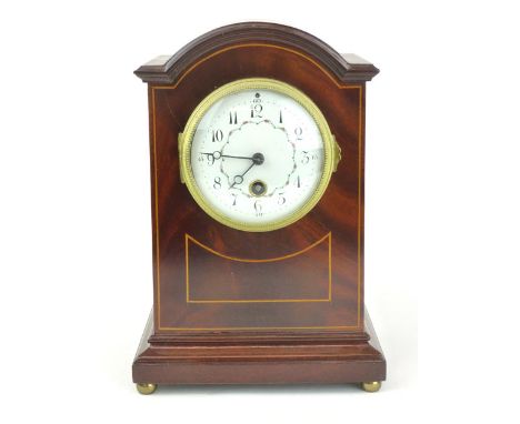 An Edwardian mahogany and boxwood inlaid mantle clock, the 3 1/2" white and floral enamelled dial on a brass movement, h. 27 
