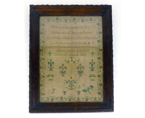 An early 19th Century sampler, dated 1831, by Olive Smith, a four line verse inside a floral border. 40 cm x 30 cm. CONDITION