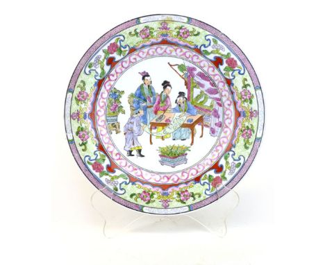 A Chinese Canton style plate, central figural scene inside a floral border, printed red seal mark, diameter 26 cm. CONDITION 